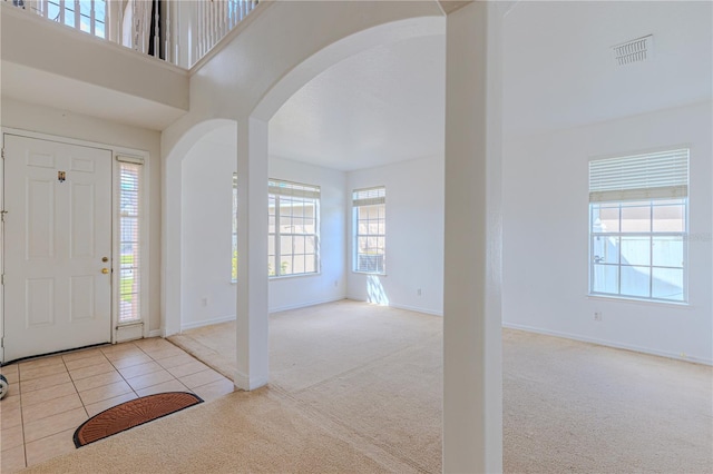 foyer entrance featuring light colored carpet