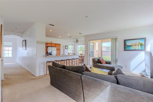 carpeted living room featuring ceiling fan