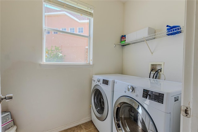 washroom with washer and dryer and light tile patterned floors