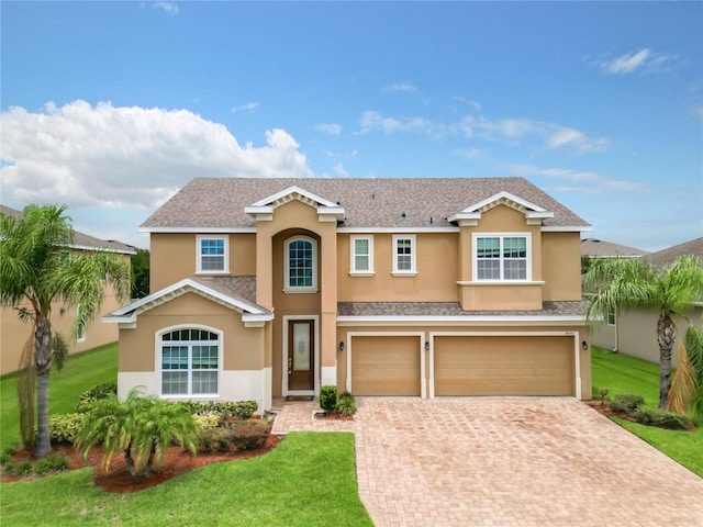 view of front facade featuring a front lawn and a garage