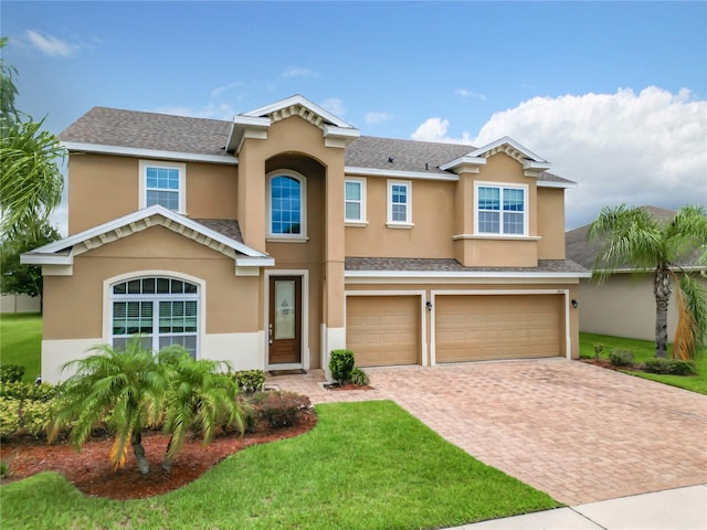 view of front of property featuring a front yard and a garage