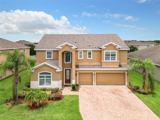 view of front of property featuring a front yard and a garage