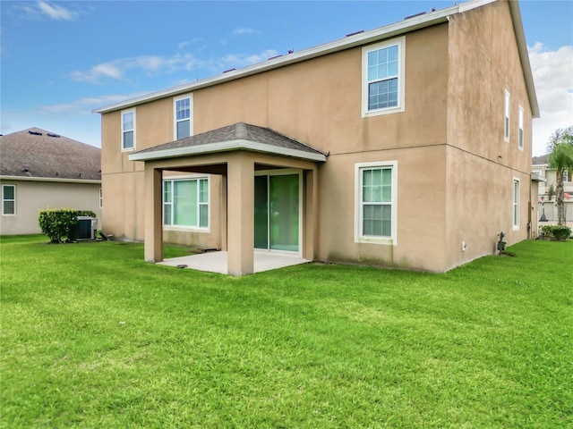 back of house with central AC, a yard, and a patio area