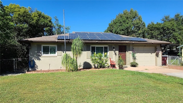 single story home featuring a front yard, a garage, and solar panels