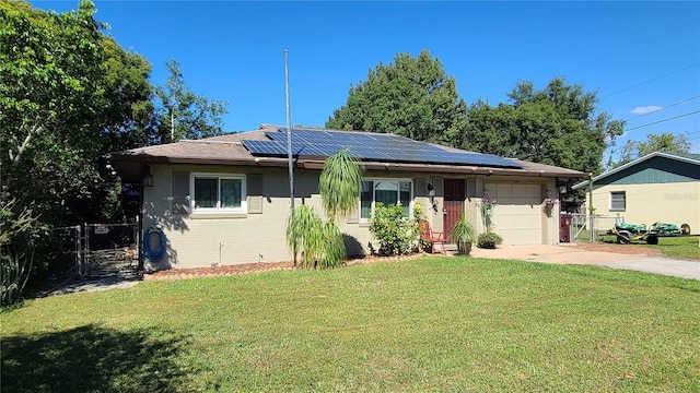 112 10th St, Saint Cloud, FL 34769 - view of front of property featuring an attached garage, driveway, solar panels, and brick siding