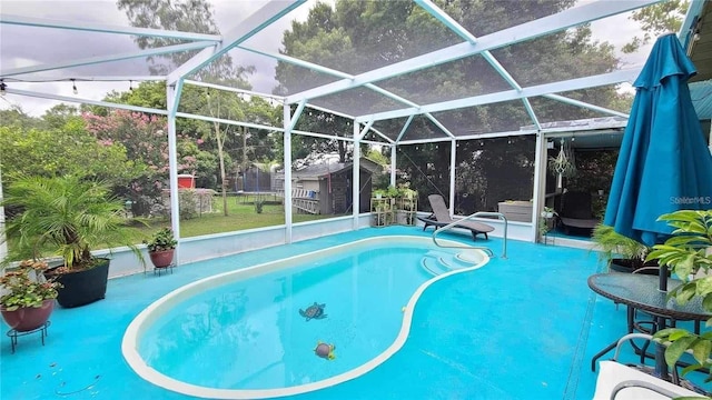 view of pool featuring an outdoor structure, a patio area, and glass enclosure