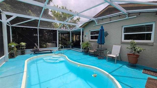 view of swimming pool with a patio area and glass enclosure