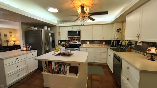 kitchen with sink, a center island, stainless steel appliances, and white cabinets