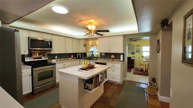 kitchen featuring a center island, stainless steel appliances, and white cabinetry