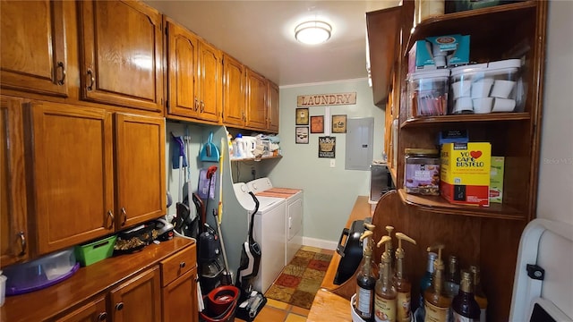 washroom featuring washer and dryer, light tile patterned floors, electric panel, crown molding, and cabinets