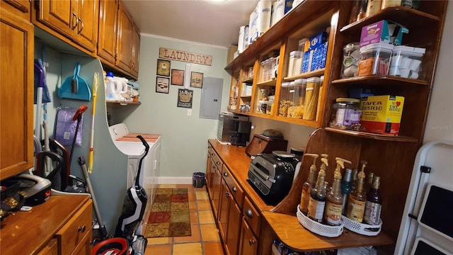 interior space featuring crown molding, washer and clothes dryer, electric panel, and light tile patterned flooring