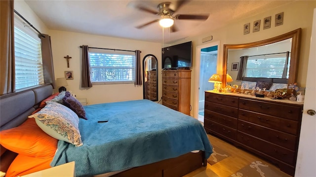 bedroom with ceiling fan and light hardwood / wood-style flooring