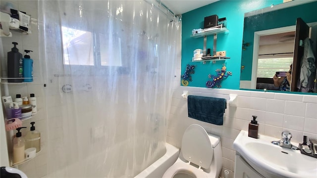 full bathroom featuring backsplash, tile walls, toilet, shower / bath combo with shower curtain, and vanity