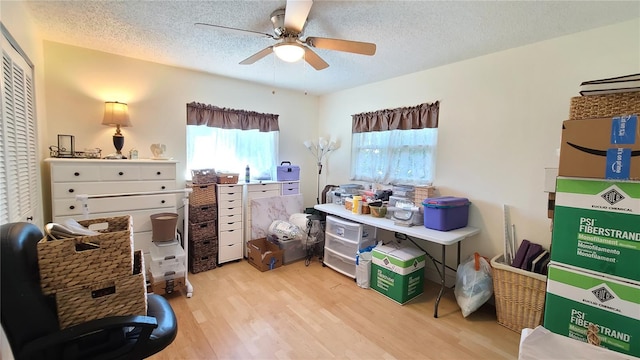 interior space with ceiling fan, a textured ceiling, and light hardwood / wood-style flooring