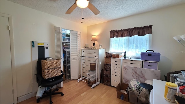 office area featuring ceiling fan, a textured ceiling, and light wood-type flooring