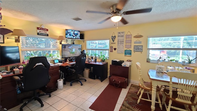 tiled office featuring a textured ceiling and ceiling fan