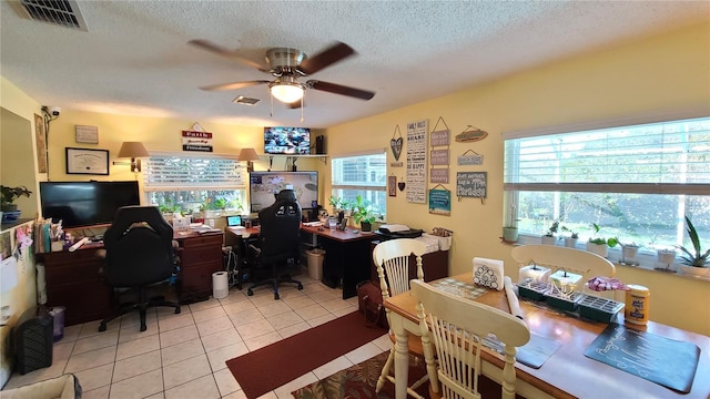 interior space with ceiling fan and a textured ceiling