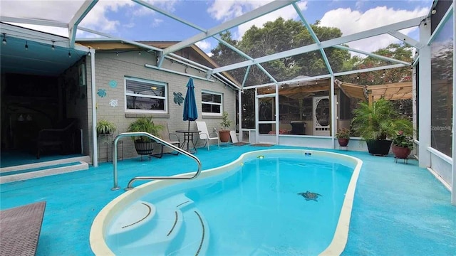 view of pool featuring a patio area and glass enclosure