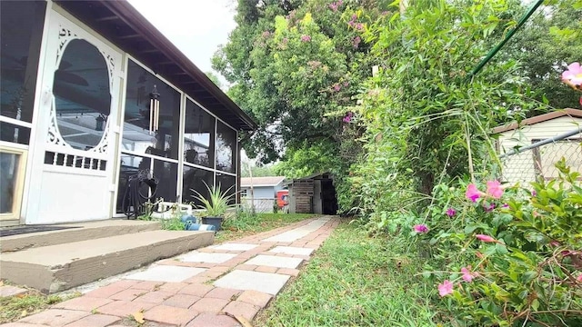 view of yard featuring a patio and a sunroom