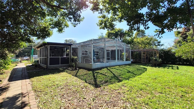 back of house featuring a yard and a lanai