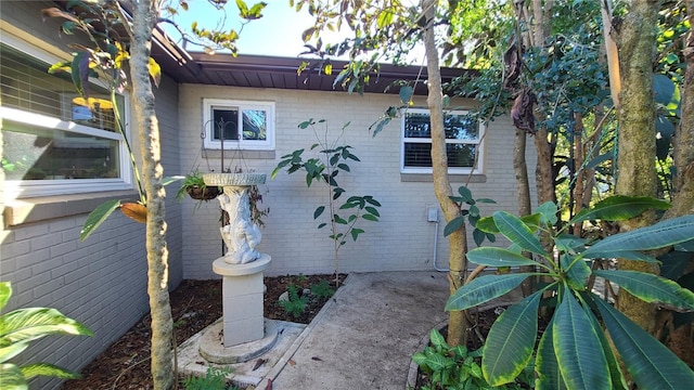 112 10th St, Saint Cloud, FL 34769 - view of side of home with brick siding