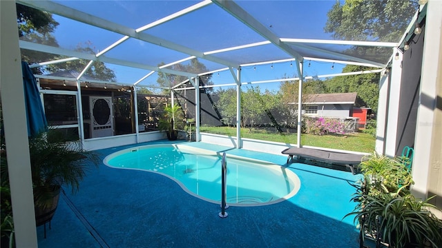 view of swimming pool featuring a lanai