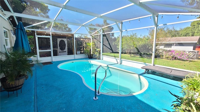 view of pool featuring a yard, a patio, and glass enclosure