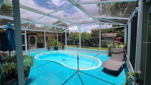 view of pool with a lanai