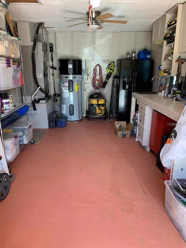 garage featuring black refrigerator with ice dispenser, hybrid water heater, sink, and ceiling fan