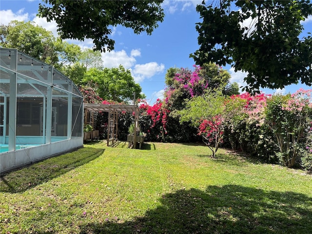 112 10th St, Saint Cloud, FL 34769 - view of grassy yard featuring glass enclosure and an outdoor pool