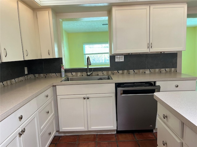 112 10th St, Saint Cloud, FL 34769 - kitchen featuring dishwasher, a sink, white cabinets, and light countertops