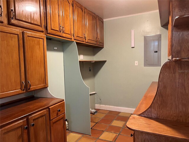 112 10th St, Saint Cloud, FL 34769 - laundry area with electric panel, tile patterned flooring, ornamental molding, and baseboards