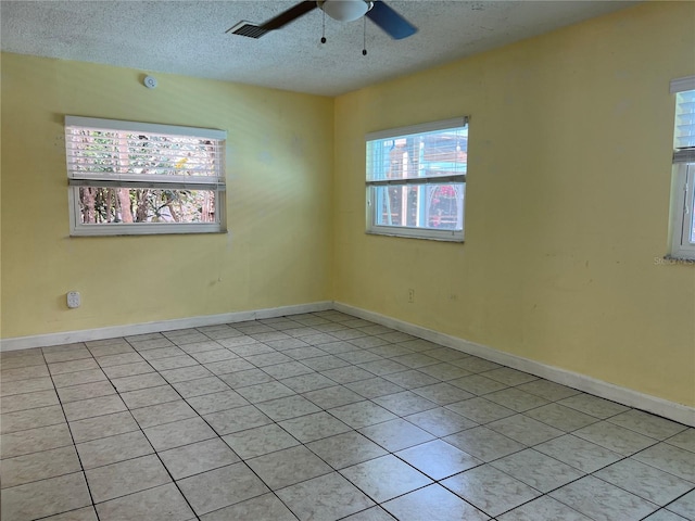 112 10th St, Saint Cloud, FL 34769 - spare room featuring ceiling fan, light tile patterned floors, a textured ceiling, and baseboards