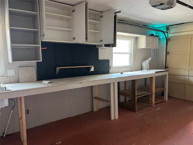 112 10th St, Saint Cloud, FL 34769 - garage featuring a workshop area and a garage door opener