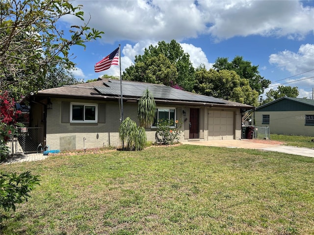 112 10th St, Saint Cloud, FL 34769 - view of front of home with brick siding, concrete driveway, a garage, and solar panels