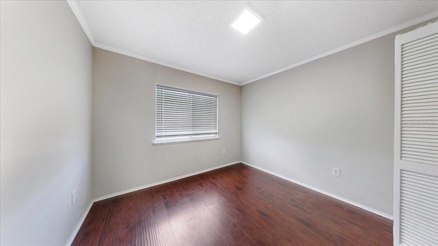 unfurnished bedroom with a textured ceiling, ornamental molding, and dark wood-type flooring