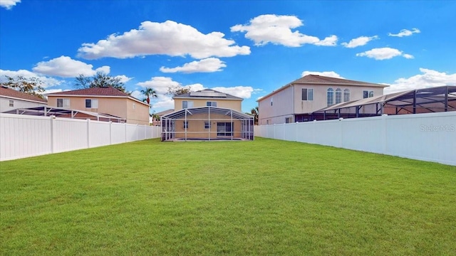 view of yard with glass enclosure