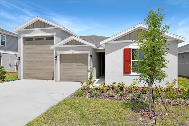 view of front of property with board and batten siding, an attached garage, driveway, and stucco siding