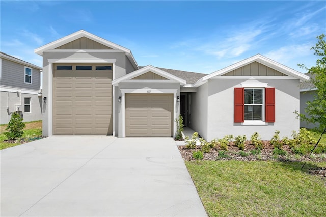 single story home with board and batten siding, an attached garage, concrete driveway, and a front yard
