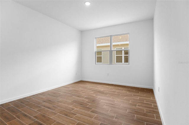 unfurnished room with recessed lighting, baseboards, and wood finished floors