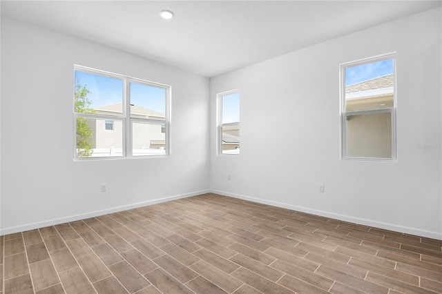 empty room featuring baseboards and wood finished floors