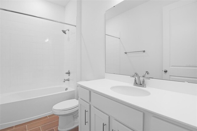 full bathroom featuring vanity, wood tiled floor, washtub / shower combination, and toilet
