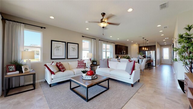 living area with recessed lighting, visible vents, and ceiling fan