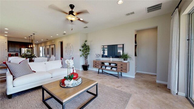 living area featuring ceiling fan, visible vents, and recessed lighting