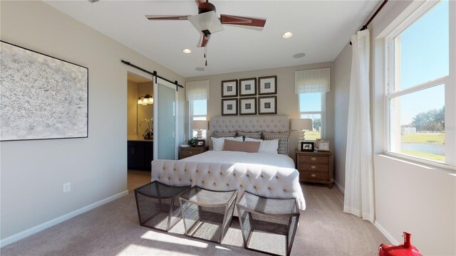 carpeted bedroom featuring a barn door, ensuite bathroom, ceiling fan, baseboards, and recessed lighting