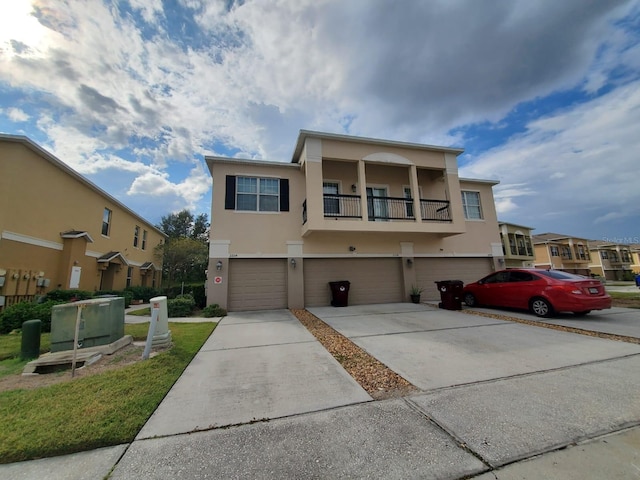 view of front of home with a garage and a balcony