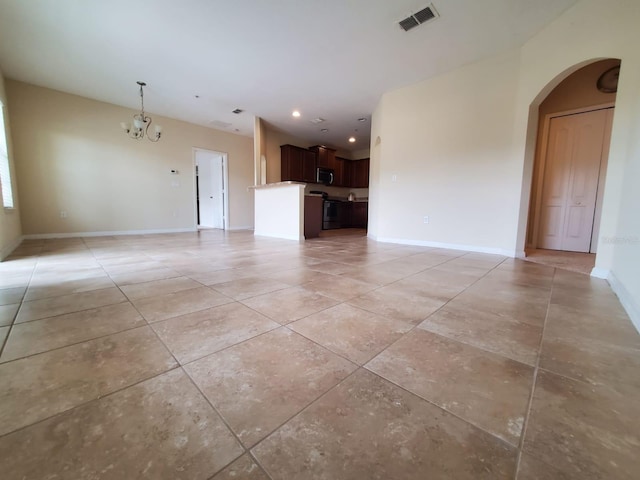 unfurnished living room featuring a notable chandelier