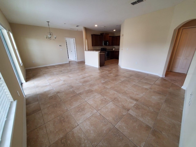 unfurnished living room with an inviting chandelier