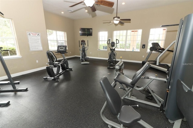 exercise room with ceiling fan, plenty of natural light, and vaulted ceiling