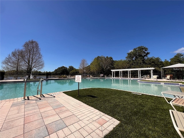 view of pool featuring a patio and a lawn